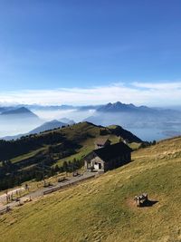 Scenic view of field and houses against sky