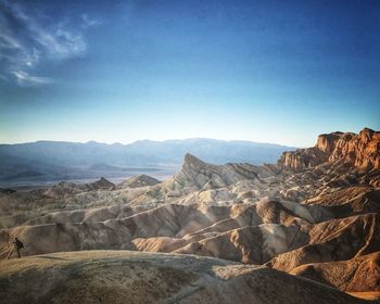 Scenic view of mountains against clear blue sky