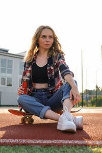 Portrait of young woman sitting outdoors