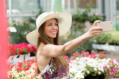 Portrait of young woman using mobile phone outdoors