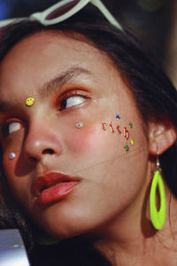 Close-up of young woman with decoration on face