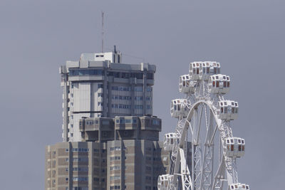 Buildings in city against clear sky