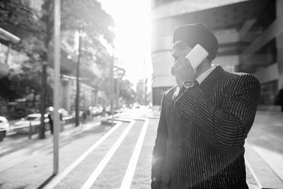 Man standing on street in city