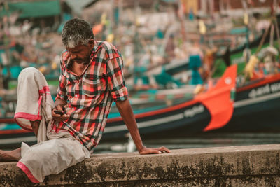 Man holding boat in water