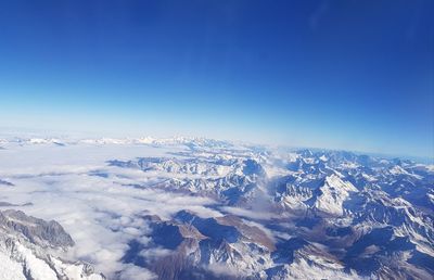 Aerial view of dramatic landscape against blue sky