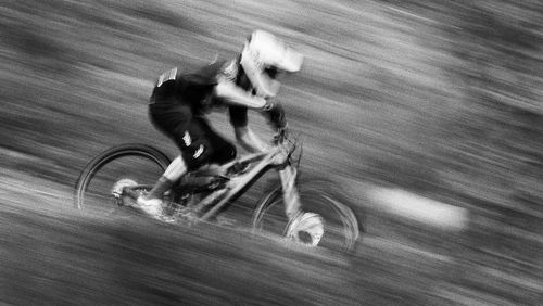 Blurred motion of man riding bicycle