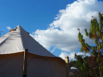 Low angle view of tent on building against sky