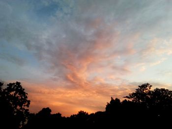 Silhouette of trees against sky at sunset