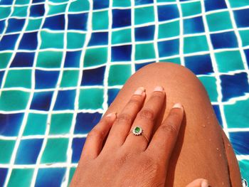 Cropped image of woman wearing ring in swimming pool