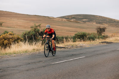 Woman riding bicycle on road