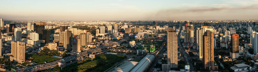 High angle view of illuminated city buildings against sky