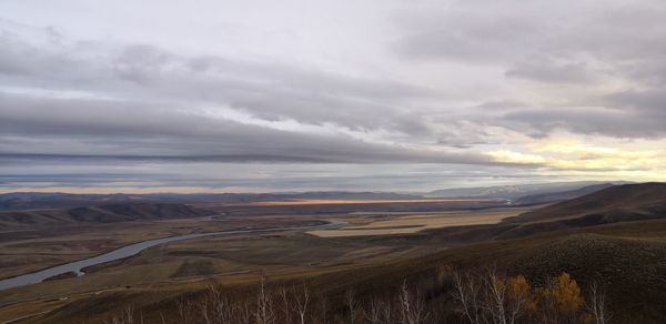 Scenic view of landscape against dramatic sky