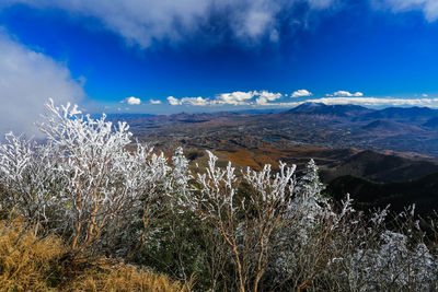 Scenic view of mountains against blue sky