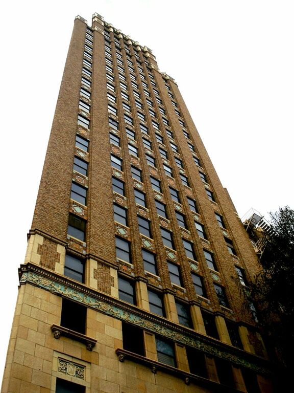 architecture, building exterior, low angle view, built structure, modern, office building, tall - high, city, clear sky, building, window, skyscraper, tower, sky, glass - material, day, tall, outdoors, no people, architectural feature