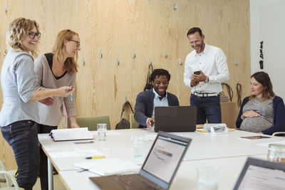 Happy business professionals in meeting at office board room