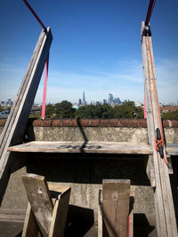 Construction site by bridge against sky