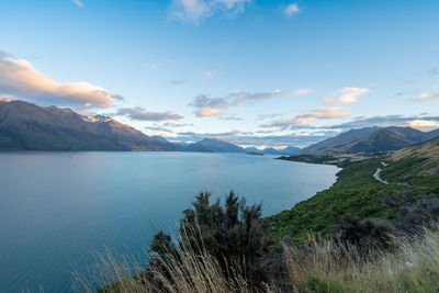 Scenic view of sea and mountains against sky