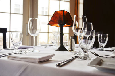 Wineglasses and lamp on restaurant table