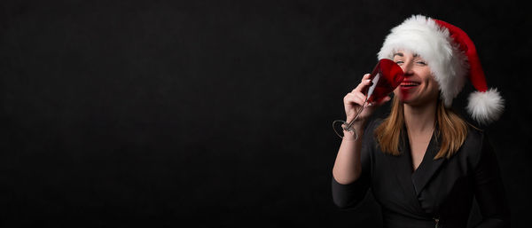 Portrait of woman with red hair against black background
