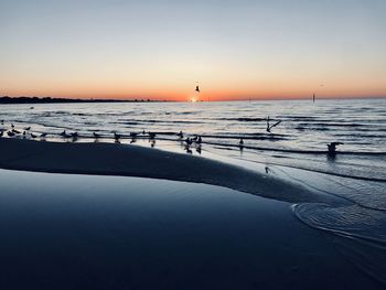 Scenic view of sea against clear sky during sunset