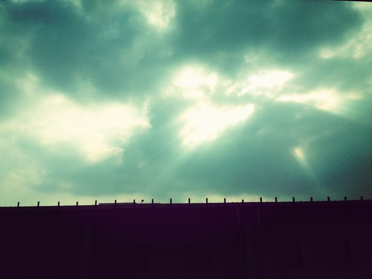 sky, cloud - sky, cloudy, low angle view, weather, cloud, silhouette, built structure, overcast, nature, storm cloud, beauty in nature, architecture, scenics, tranquility, outdoors, dusk, no people, cloudscape, tranquil scene