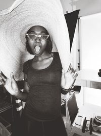 Portrait of young woman wearing hat at home