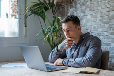 Young man using laptop at office
