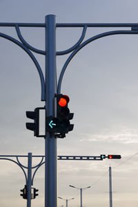 Road sign against sky