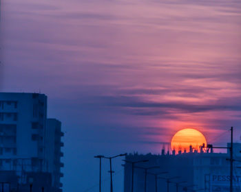 Low angle view of buildings against sky during sunset