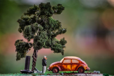 Close-up of toy on table by tree