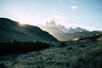 Scenic view of snowcapped mountain peak against sunset sky