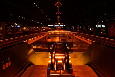 Illuminated escalator in city at night