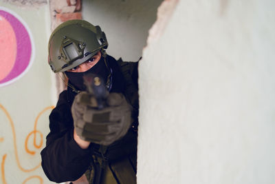 Army soldier aiming gun in building