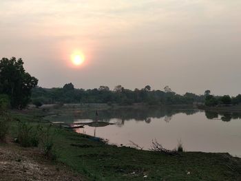 Scenic view of lake against sky during sunset