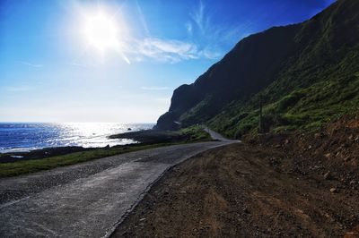 Road by sea against sky