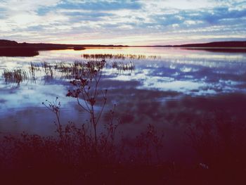 Scenic view of lake at sunset