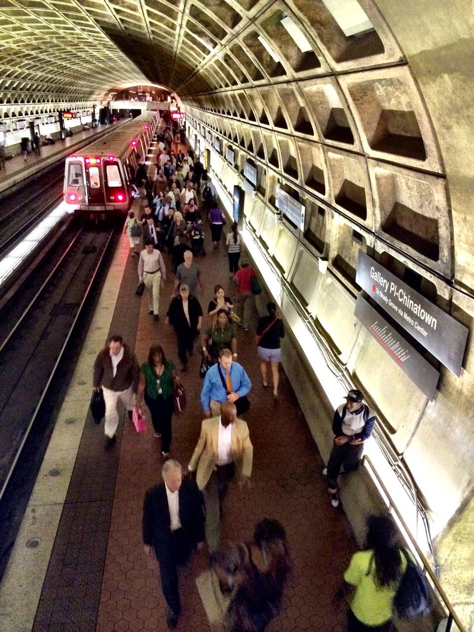 large group of people, men, lifestyles, person, high angle view, transportation, leisure activity, railroad station, built structure, architecture, walking, city life, travel, rail transportation, railroad track, steps and staircases, steps, railroad station platform, escalator