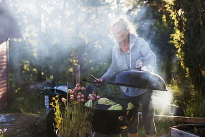 Woman having barbecue