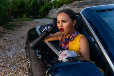 Side view of women sitting in car