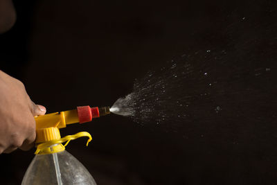 Close-up of hand pouring water from bottle