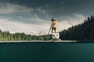 A young woman enjoys a standup paddle board on lost lake in oregon.