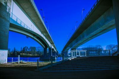 Low angle view of bridge against blue sky