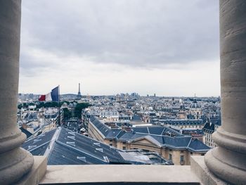 Cityscape against cloudy sky