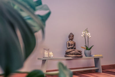 View of buddha statue on table