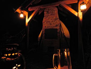 Low angle view of illuminated light bulbs at night