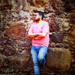 Young woman standing on rock formation