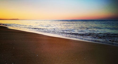 Scenic view of beach at sunset