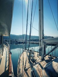 Sailboats moored in harbor