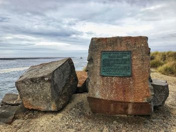 View of rocks on beach against sky