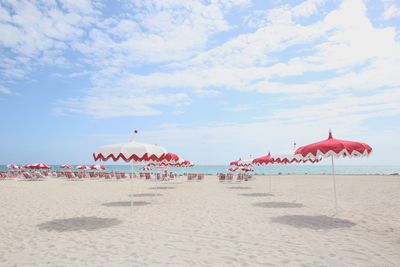 Umbrellas on beach against sky